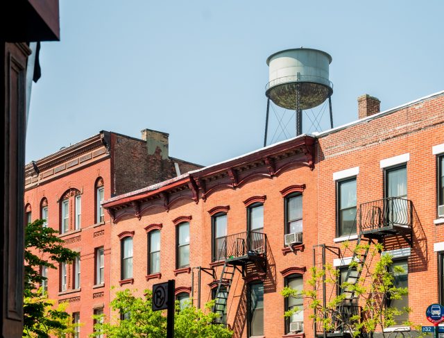 Apartment,Buildings,With,Water,Tower,On,The,Background