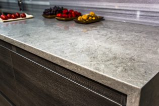 Stone,Gray,Worktop,With,Dark,Kitchen,Cabinets,,Granite,Countertop,Over